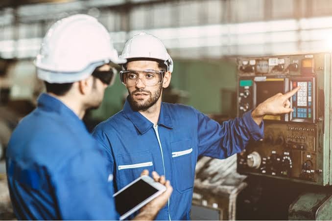Maintenance engineers reviewing reliability strategy for plant equipment